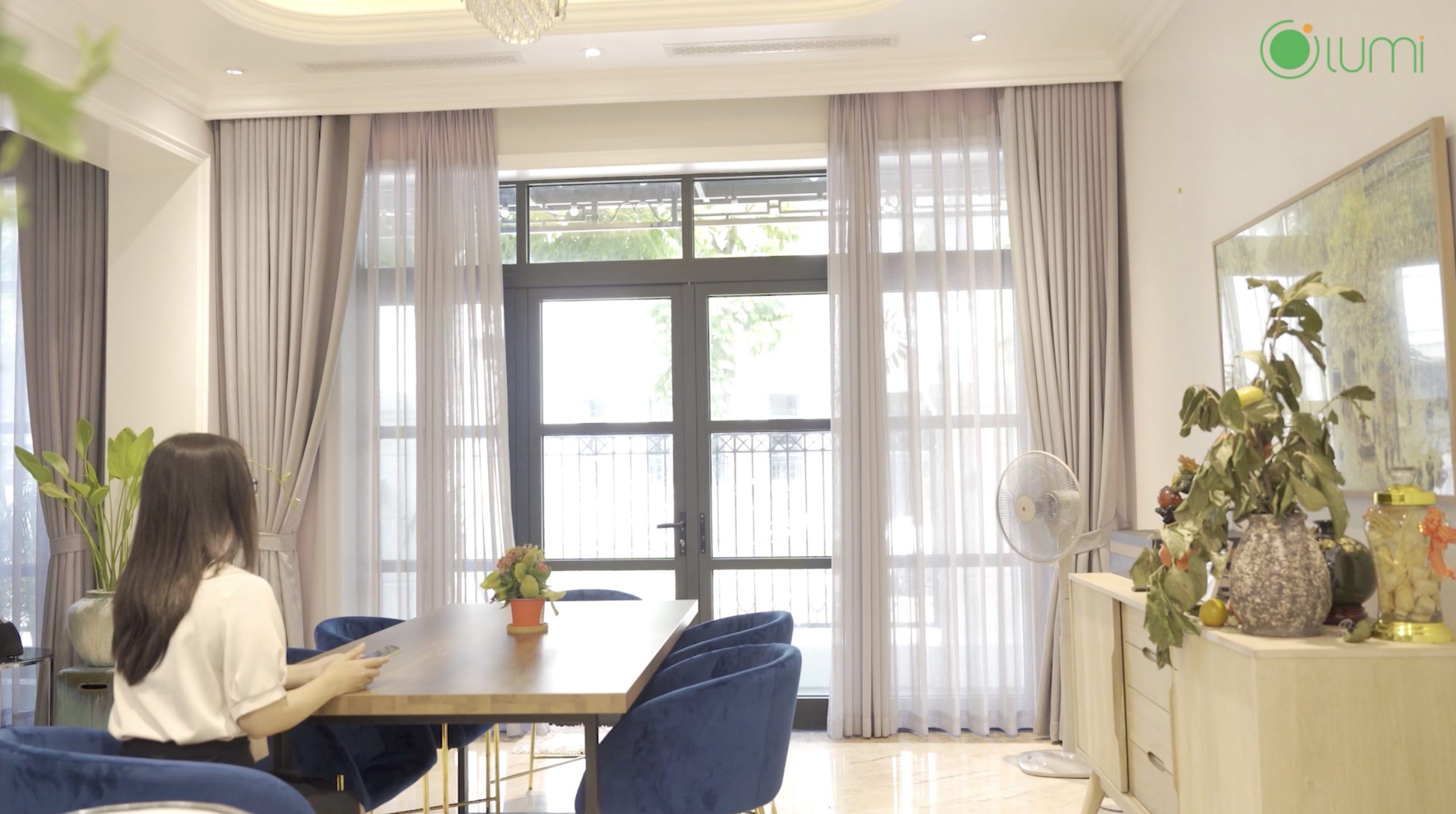 Nội thất đơn giản với sự kết hợp giữa tường trắng, gạch sàn đá hoa cương cùng sofa nhung xanh sang trọng